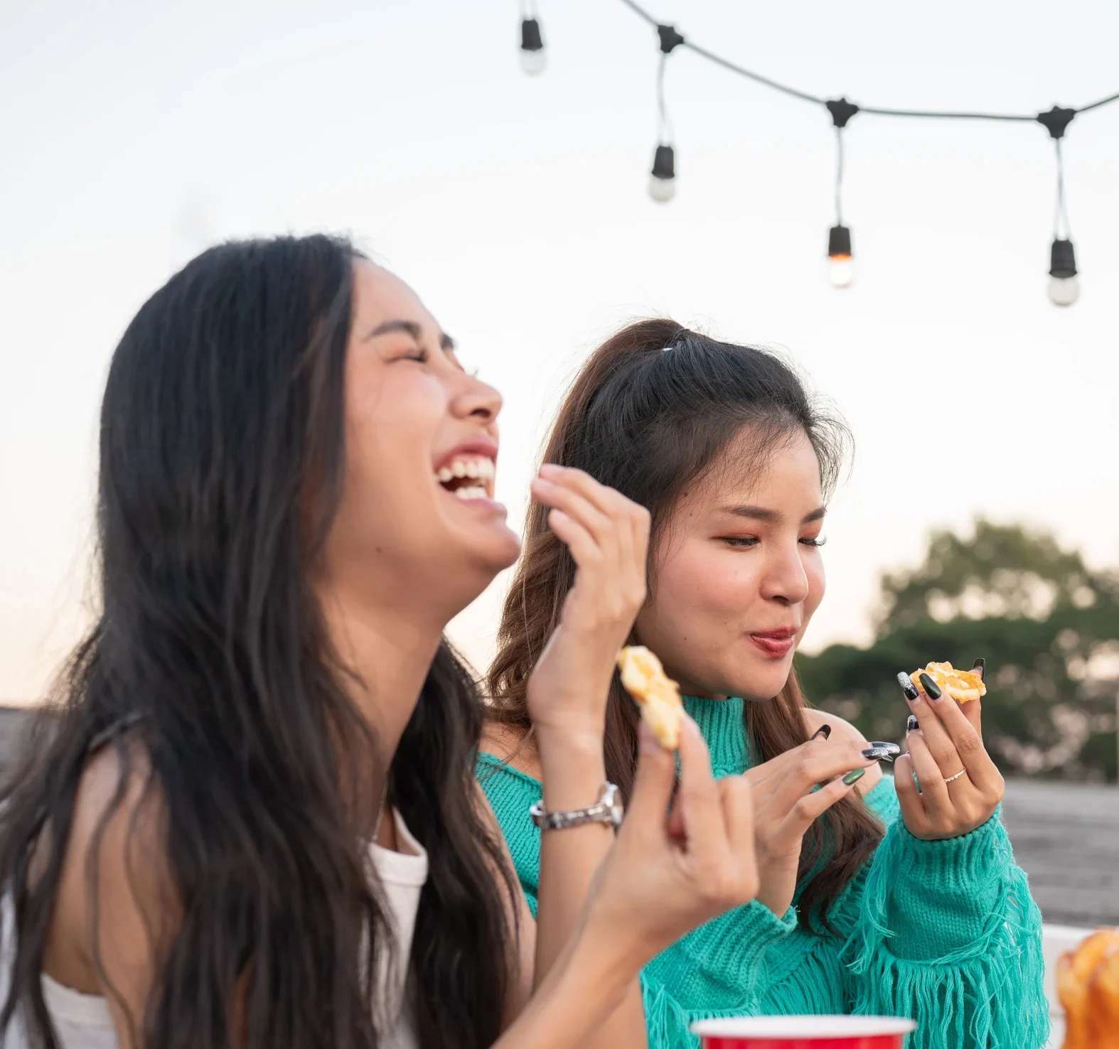 Group Of Cheerful Young Asian Female Friends Laughing Enjoying Talking And Eating